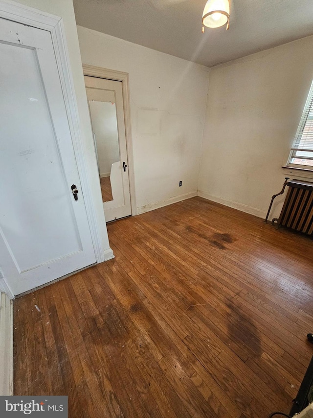 3 W Elm Ave, Baltimore, MD 21206 - unfurnished room with hardwood / wood-style floors, radiator heating unit, and baseboards