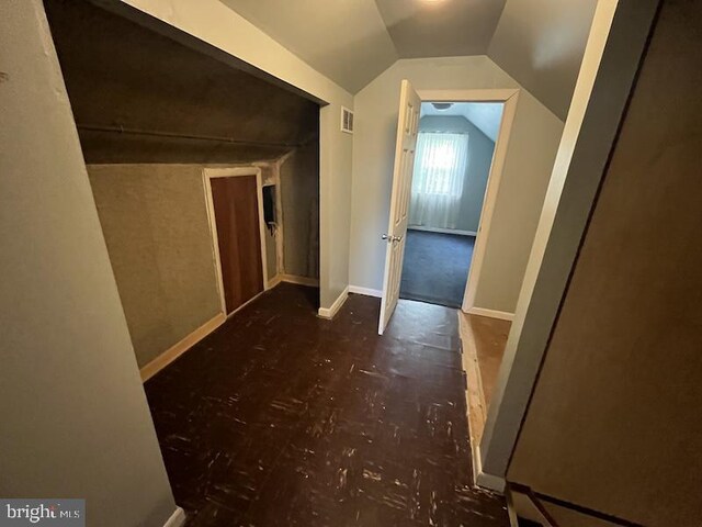 hall featuring lofted ceiling
