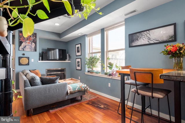living area with wood finished floors and baseboards