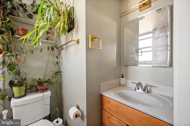 half bath featuring toilet and vanity