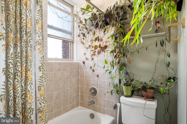bathroom with plenty of natural light, toilet, and shower / bath combination