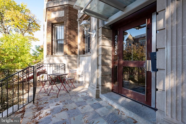 view of exterior entry with outdoor dining area