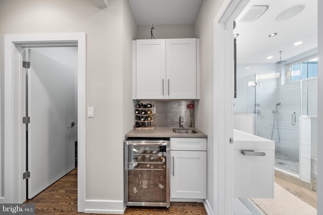 721 S Smedley St, Philadelphia, PA 19146 - indoor wet bar with beverage cooler, wood finished floors, decorative backsplash, and recessed lighting