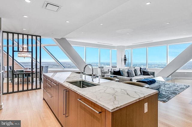 50 S 16th St Unit 5401, Philadelphia, PA 19102 - kitchen with a sink, light wood-type flooring, open floor plan, a kitchen island with sink, and floor to ceiling windows