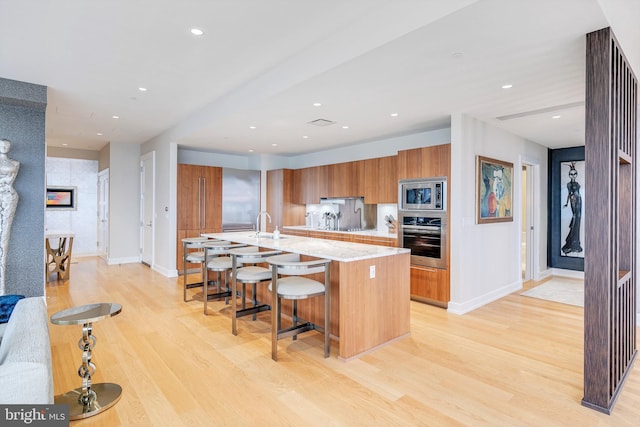 50 S 16th St Unit 5401, Philadelphia, PA 19102 - kitchen featuring stainless steel appliances, brown cabinets, baseboards, modern cabinets, and recessed lighting
