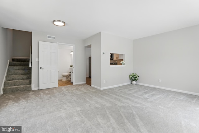 9928 Brookridge Ct, Gaithersburg, MD 20886 - unfurnished living room with stairway, baseboards, and carpet