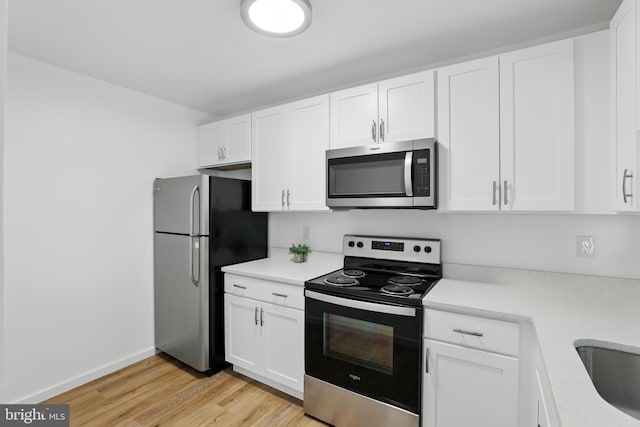 9928 Brookridge Ct, Gaithersburg, MD 20886 - kitchen featuring stainless steel appliances, light wood-style flooring, light countertops, and white cabinets