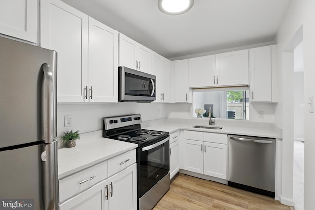 9928 Brookridge Ct, Gaithersburg, MD 20886 - kitchen featuring stainless steel appliances, a sink, light countertops, and white cabinetry
