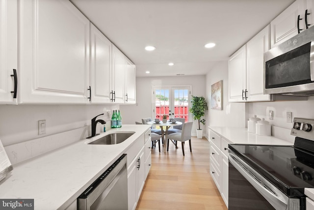 2532 Sedgewick Pl, Dumfries, VA 22026 - kitchen featuring stainless steel appliances, a sink, recessed lighting, light wood-style floors, and white cabinetry