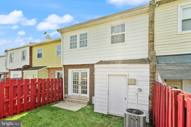 back of property with central air condition unit and brick siding