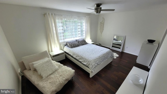 bedroom with dark wood finished floors, baseboards, and ceiling fan