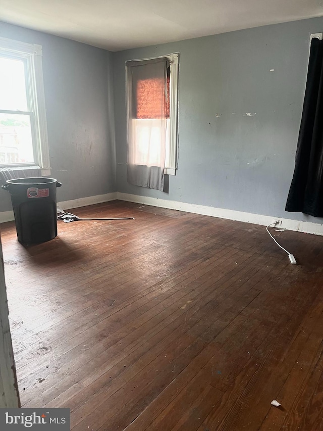 435 S Augusta Ave, Baltimore, MD 21229 - empty room with plenty of natural light, hardwood / wood-style flooring, and baseboards