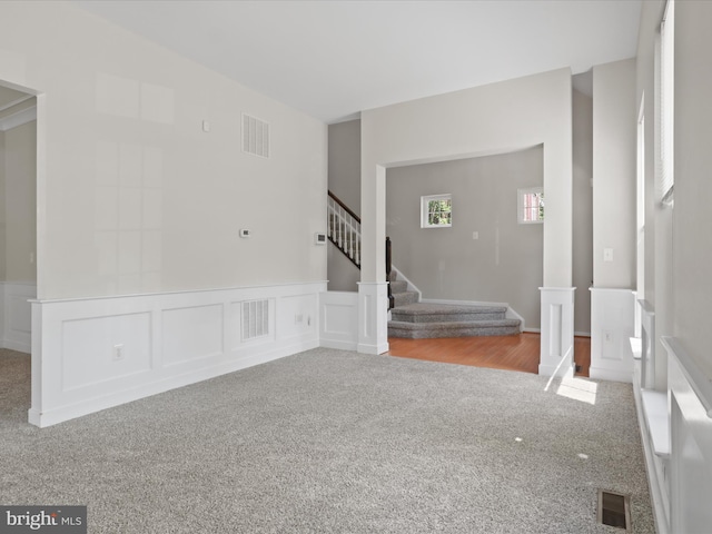 17494 Lethridge Cir, Round Hill, VA 20141 - unfurnished room featuring carpet floors, stairway, wainscoting, and a decorative wall