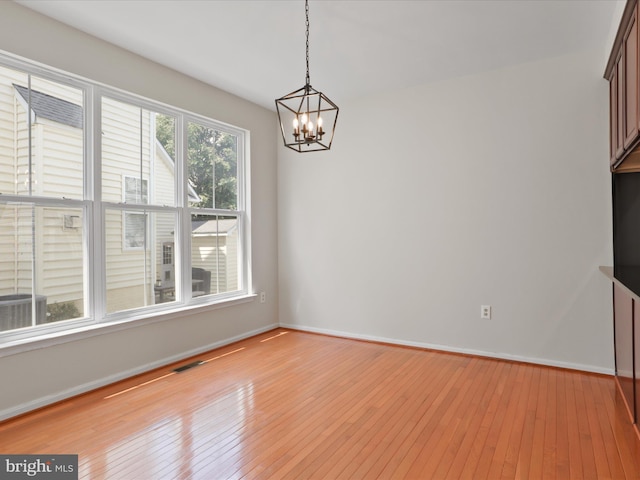 17494 Lethridge Cir, Round Hill, VA 20141 - unfurnished dining area featuring a chandelier and light wood-style flooring
