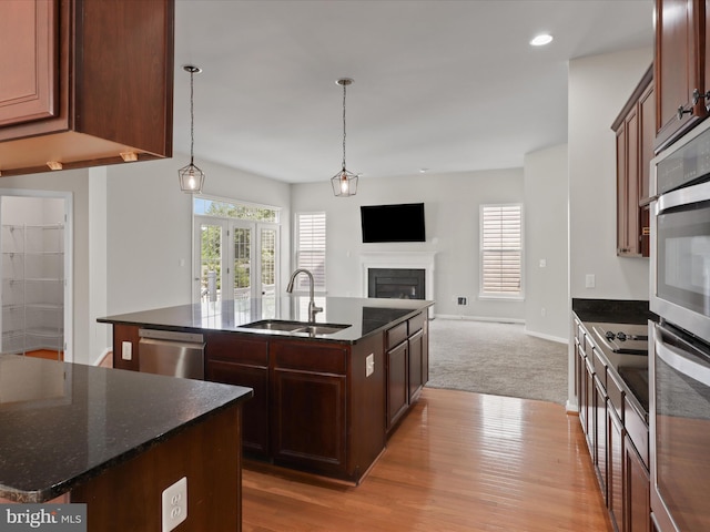 17494 Lethridge Cir, Round Hill, VA 20141 - kitchen with a kitchen island with sink, dishwasher, open floor plan, dark stone countertops, and healthy amount of natural light