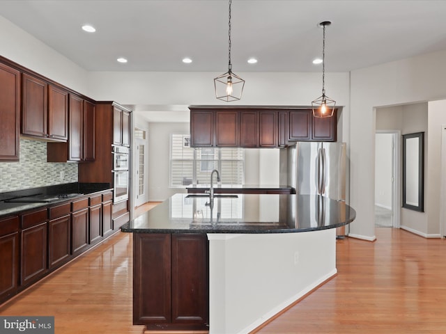 17494 Lethridge Cir, Round Hill, VA 20141 - kitchen featuring light wood finished floors, a kitchen island with sink, appliances with stainless steel finishes, tasteful backsplash, and recessed lighting