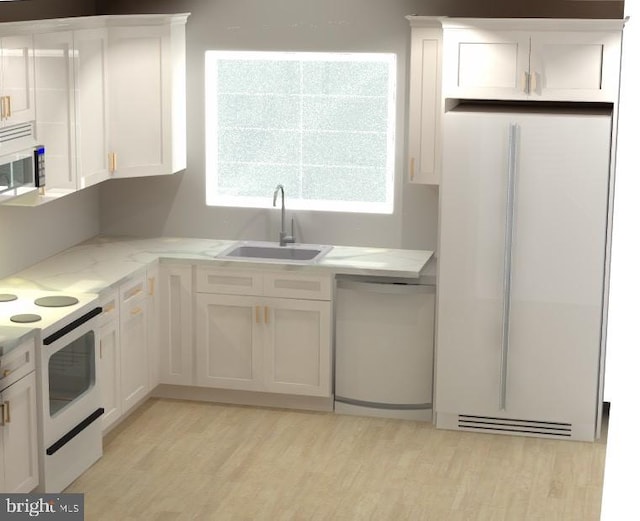 kitchen with white appliances, a sink, light wood-style floors, white cabinetry, and light stone countertops