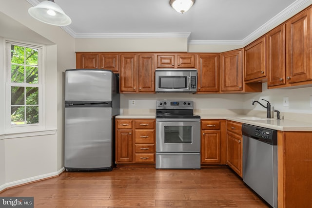 103 Barnsfield Ct Unit 227, Gaithersburg, MD 20878 - kitchen with stainless steel appliances, crown molding, a sink, light countertops, and brown cabinetry