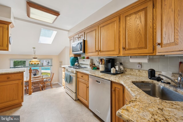 2 Tomahawk Dr, Marlton, NJ 08053 - kitchen with stainless steel appliances, a sink, a skylight, lofted ceiling, and light stone countertops