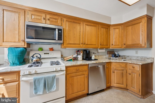 2 Tomahawk Dr, Marlton, NJ 08053 - kitchen with appliances with stainless steel finishes, a sink, backsplash, and light stone countertops