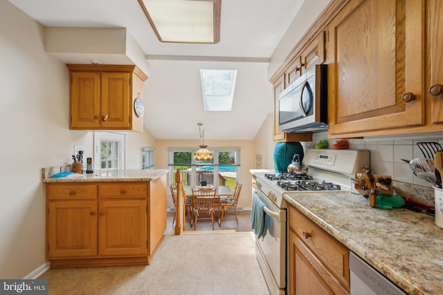 2 Tomahawk Dr, Marlton, NJ 08053 - kitchen with white appliances, a skylight, brown cabinets, light stone countertops, and vaulted ceiling