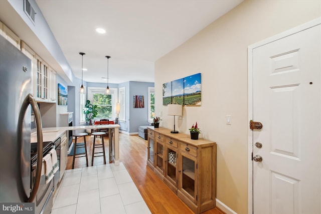 1725 Willard St NW Unit 3, Washington, DC 20009 - kitchen featuring freestanding refrigerator, range with electric cooktop, recessed lighting, decorative light fixtures, and light wood-style flooring