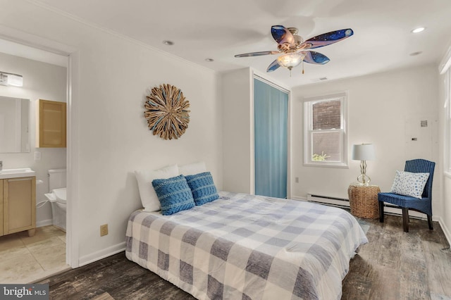735 Shore Dr, Edgewater, MD 21037 - bedroom with a baseboard radiator, light wood-style floors, baseboards, recessed lighting, and a sink