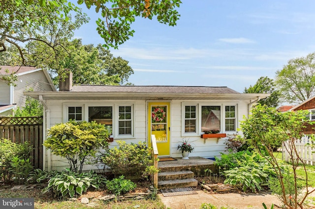735 Shore Dr, Edgewater, MD 21037 - view of front of house featuring fence, a chimney, and a shingled roof