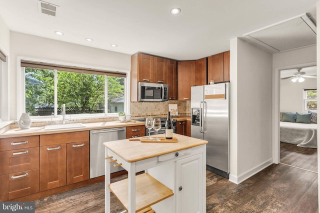 735 Shore Dr, Edgewater, MD 21037 - kitchen featuring appliances with stainless steel finishes, a sink, light countertops, tasteful backsplash, and dark wood-style floors