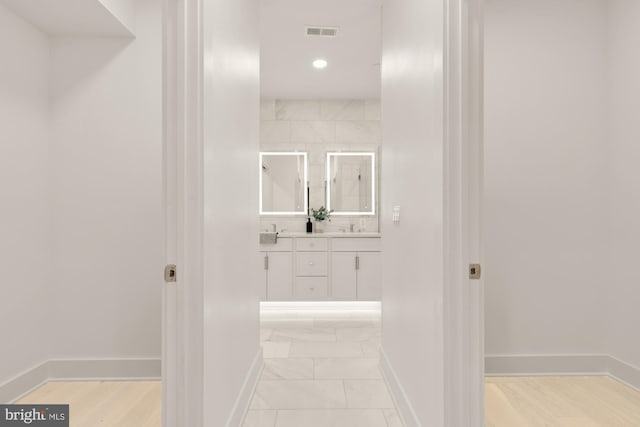 503 L St NE Unit B, Washington, DC 20002 - hall with baseboards, recessed lighting, light marble finish floors, and a sink