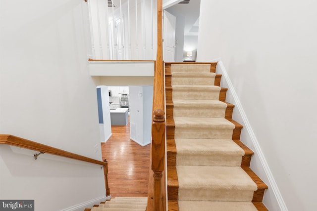 42030 Zircon Dr, Aldie, VA 20105 - stairs featuring wood finished floors, baseboards, and a high ceiling