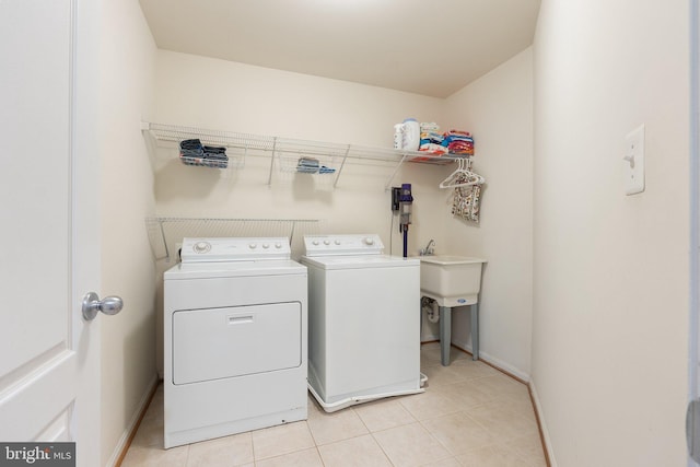42030 Zircon Dr, Aldie, VA 20105 - laundry room featuring washer and dryer, light tile patterned floors, and baseboards