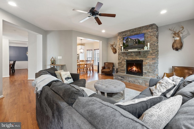 42030 Zircon Dr, Aldie, VA 20105 - living area with wood finished floors, a stone fireplace, a ceiling fan, recessed lighting, and baseboards