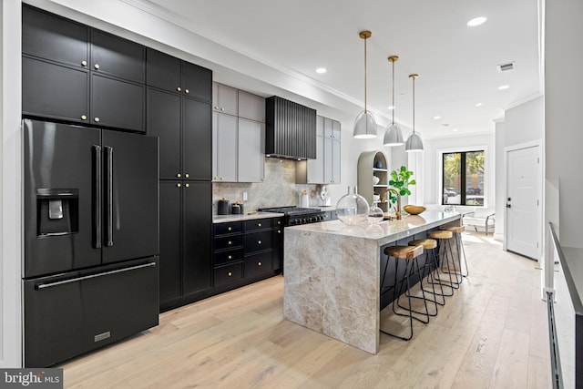 1407 1st St NW Unit 1, Washington, DC 20001 - kitchen featuring high end black refrigerator, gas stove, crown molding, light wood-style floors, and decorative backsplash
