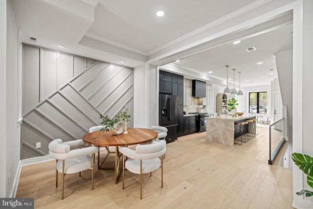 1407 1st St NW Unit 1, Washington, DC 20001 - dining space with stairs, light wood-type flooring, crown molding, recessed lighting, and arched walkways