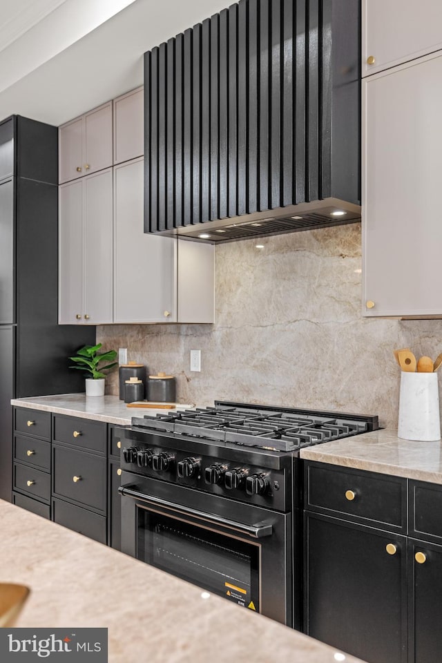 1407 1st St NW Unit 1, Washington, DC 20001 - kitchen featuring gas stove, wall chimney exhaust hood, light countertops, and tasteful backsplash