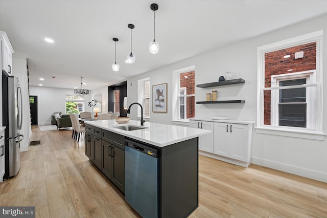 642 S 51st St, Philadelphia, PA 19143 - kitchen with a sink, appliances with stainless steel finishes, white cabinets, light countertops, and light wood-type flooring