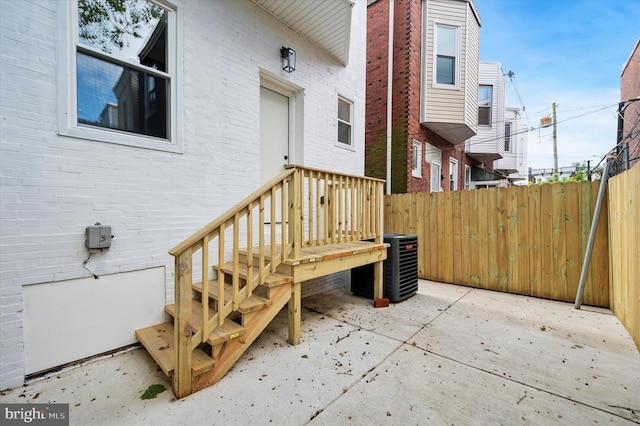 642 S 51st St, Philadelphia, PA 19143 - property entrance featuring brick siding, central AC unit, and fence