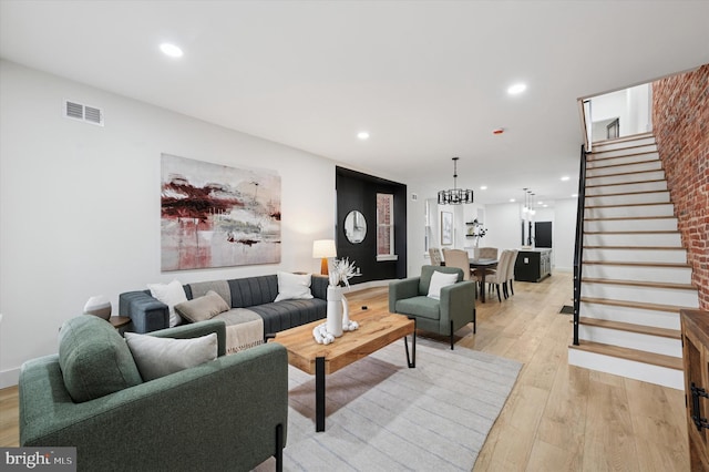 642 S 51st St, Philadelphia, PA 19143 - living room with stairway, light wood-style floors, recessed lighting, and a chandelier