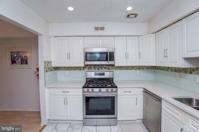 48 Bonnie Gellman Ct Unit B48, Philadelphia, PA 19114 - kitchen with appliances with stainless steel finishes, white cabinets, light countertops, decorative backsplash, and recessed lighting