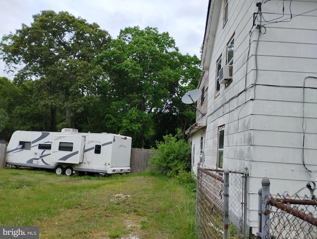 view of yard featuring fence and cooling unit