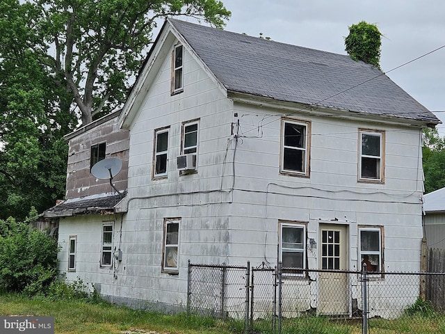 view of home's exterior featuring a shingled roof and cooling unit