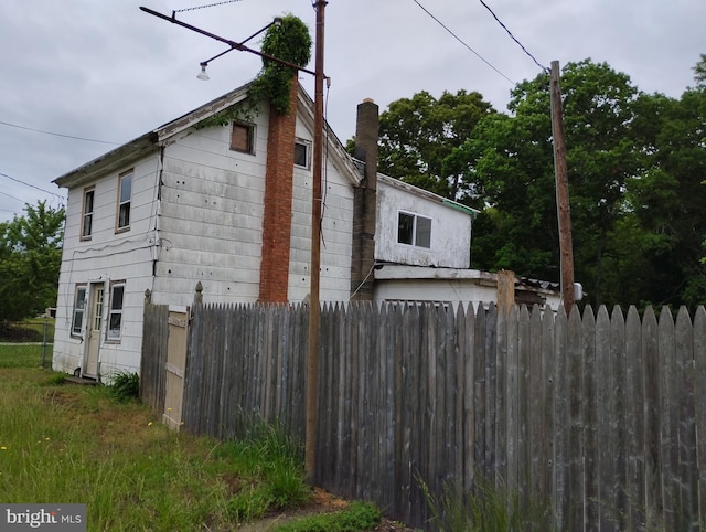 view of side of home with fence
