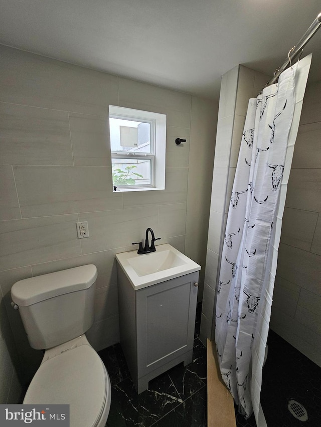 3173 Salmon St, Philadelphia, PA 19134 - bathroom featuring tiled shower, marble finish floors, toilet, vanity, and tile walls