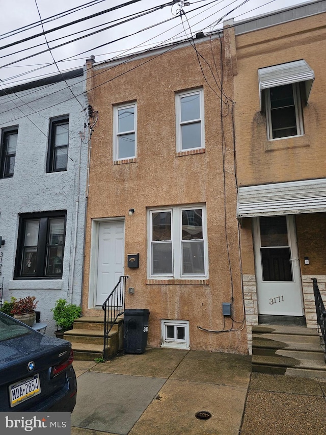 3173 Salmon St, Philadelphia, PA 19134 - view of property featuring stucco siding and entry steps