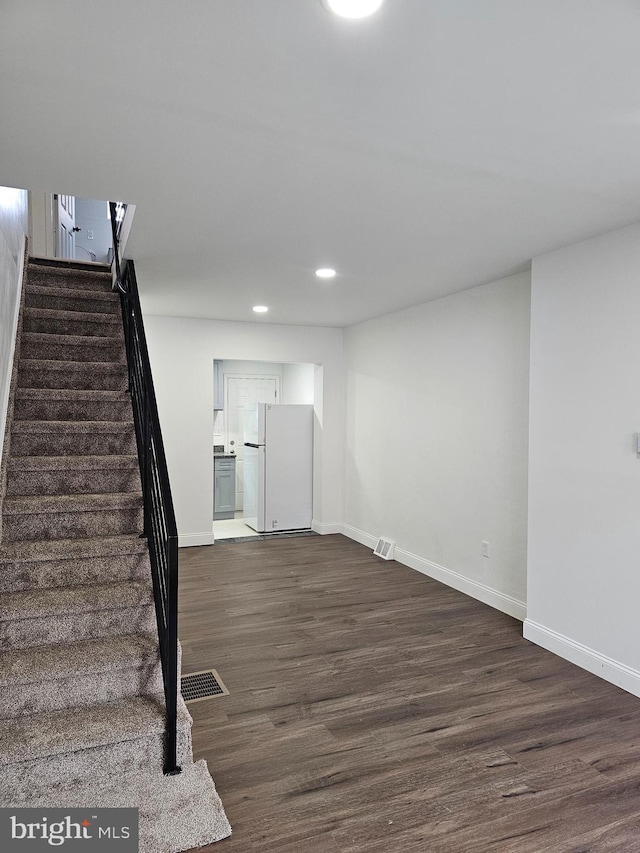 3173 Salmon St, Philadelphia, PA 19134 - basement featuring freestanding refrigerator, dark wood finished floors, stairway, recessed lighting, and baseboards