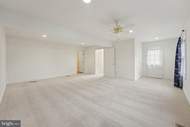 empty room with recessed lighting, a ceiling fan, light colored carpet, and baseboards