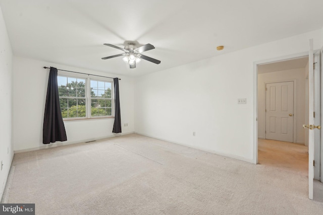 carpeted empty room with ceiling fan