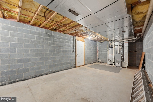 unfinished below grade area featuring gas water heater and heating unit