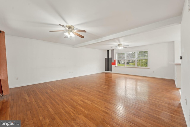 unfurnished living room featuring ceiling fan, wood-type flooring, and baseboards